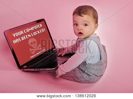 Adorable baby with laptop infected by a ransomware virus which says the computer has been locked.