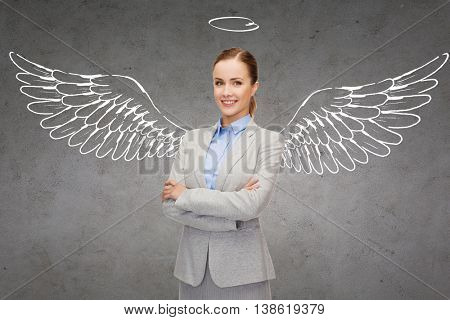 business, angel investor, safety, security and people concept - smiling young businesswoman with wings and nimbus drawing over gray concrete background