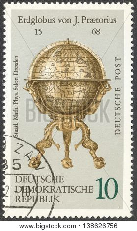 MOSCOW RUSSIA - CIRCA FEBRUARY 2016: a post stamp printed in DDR shows a vintage globe the series 