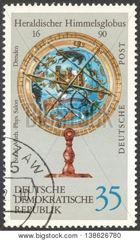 MOSCOW RUSSIA - CIRCA FEBRUARY 2016: a post stamp printed in DDR shows heraldic sky-globe the series 
