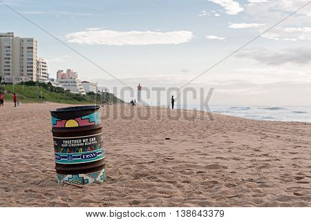DURBAN SOUTH AFRICA - MARCH 12 2016: Trash can on the beach near fisherman in Umhlanga Rocks