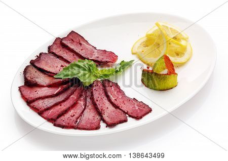 appetizing restaurant food -basturma with lemon on  white background