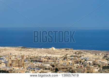 Background center shows San Dimitri chapel with in the foreground the village of Gharb