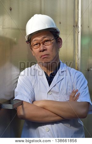 A QC Engineer looking at the camera in a grumpy manner