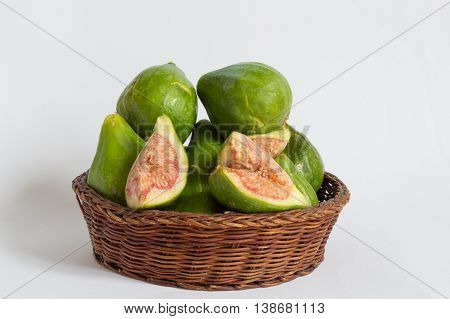 Figs in a wicker basket on a white background