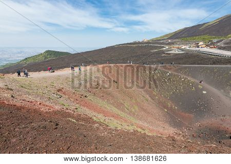 MOUNT ETNA ITALY - MAY 23: Tourists walking around Silvestri crater at the slopes of Mount Etna on May 23 2016 at the island Sicily Italy