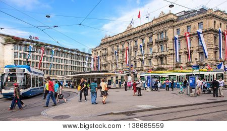 Zurich, Switzerland - 1 August, 2014: view on Paradeplatz square from Bahnhofstrasse street. Zurich is the largest city in Switzerland and the capital of the Swiss canton of Zurich.