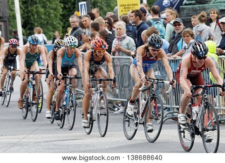 STOCKHOLM - JUL 02 2016: Group of female triathlete cyclists and audience in the Women's ITU World Triathlon series event July 02 2016 in Stockholm Sweden