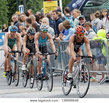 STOCKHOLM - JUL 02 2016: Group of female triathlete cyclists and audience in the Women's ITU World Triathlon series event July 02 2016 in Stockholm Sweden