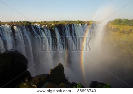 Powerful Victoria falls with rainbow, seen from Zimbabwe side