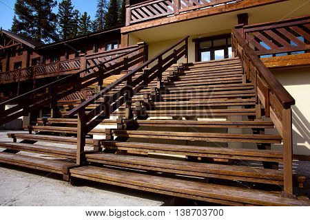 A wide wooden staircase at the entrance to the house. Large terrace.