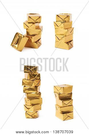 Stack of mulitple bouillon stock broth cubes wrapped in golden foil, composition isolated over the white background, set of four different foreshortenings