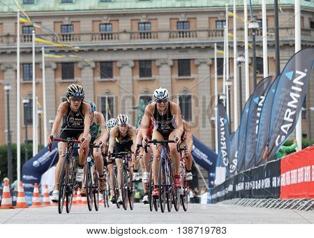 STOCKHOLM - JUL 02 2016: Large group of female triathlete cyclists from a low angle the royal castle in background in the Women's ITU World Triathlon series event July 02 2016 in Stockholm Sweden