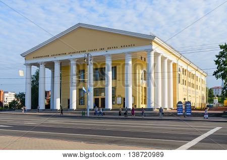 VITEBSK BELARUS - JULY 13 2016: Unidentified people stand at bus stop near National Academic Drama Theater named after Yakub Kolas Vitebsk Belarus