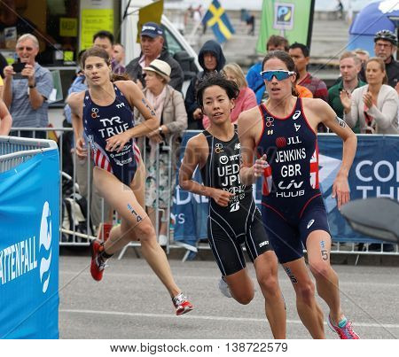 STOCKHOLM - JUL 02 2016: Triathletes Jenkins Ueda and True running in a curve in the Women's ITU World Triathlon series event July 02 2016 in Stockholm Sweden