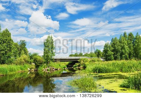 Beautiful landscape unusually combining a road bridge across the river and the beauty of nature