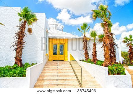 White House With Palms On Blue Sky