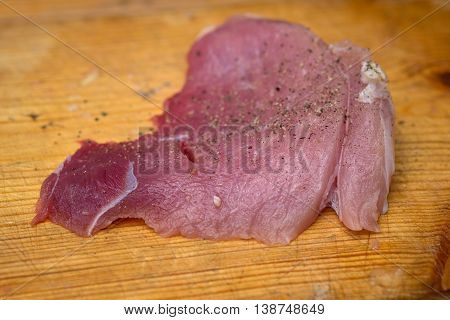 Closeup Menin The Kitchen Is Cutting Pork On Cutting Board