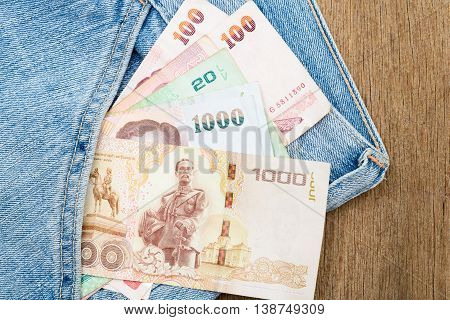 Close up of Thai baht banknotes in jeans pocket.