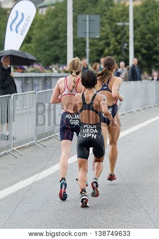 STOCKHOLM - JUL 02 2016: Rear view of Ai Ueda and group of running triathletes in the Women's ITU World Triathlon series event July 02 2016 in Stockholm Sweden
