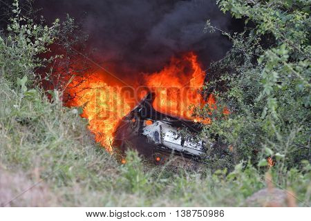 TULCEA, ROMANIA - JUNE 11: Danube Delta Rally special trial windfarm on June 11, 2016 in Tulcea, Romania; car on fire