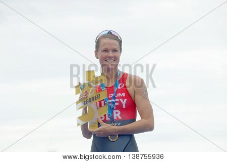 STOCKHOLM - JUL 02 2016: Flora Duffy on the winner's stand holding the trophy in the Women's ITU World Triathlon series event July 02 2016 in Stockholm Sweden