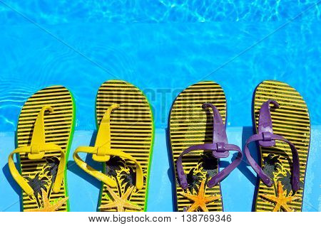 Flip-flops and starfish in the pool background.