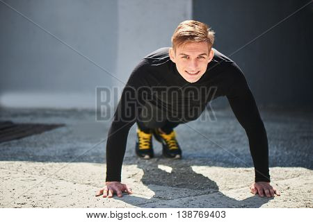 Portrait of an athlete in tight clothing performing a warm-up