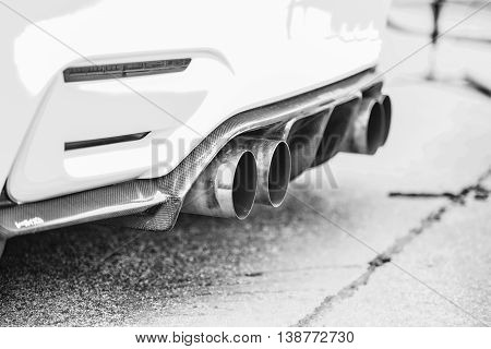 Double Exhaust Pipes Of A Modern Sports Car, Black And White