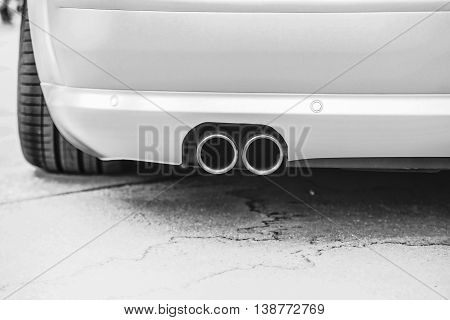 Double Exhaust Pipes Of A Modern Sports Car, Black And White