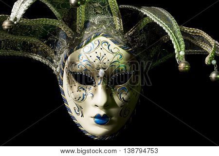 Beautiful venezian souvenir mask with jingles on black background