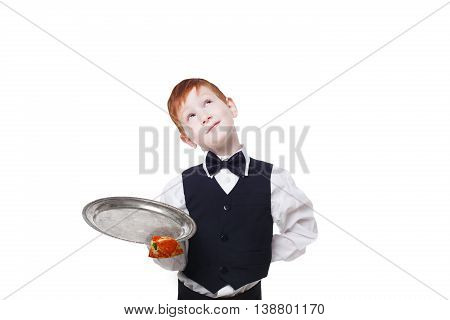 Clumsy little waiter drops tray with small pizza piece while dreaming. Food falling down. Redhead child boy in suit shows inattentive waiter failure at white background