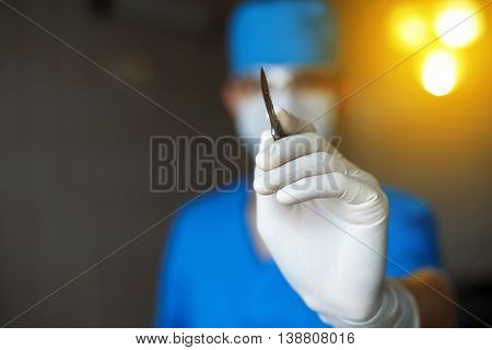 Plastic Doctor With A Scalpel In His Hand Starts To Operate. Professional Surgeon In The Operating R