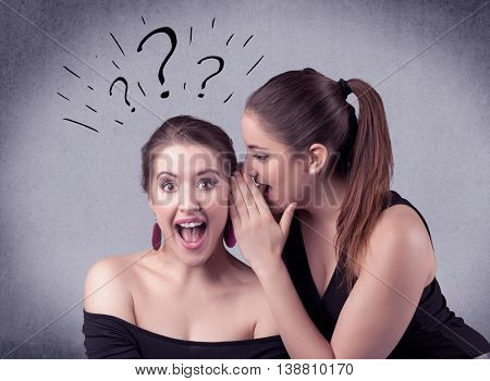 A teenager girl looking confused with drawn question marks above the head, while a girlfriend whispers something in her ear concept.