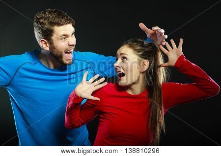Husband abusing wife. Aggresive man screaming at scared afraid woman. Domestic violence aggression. Bad relationship.