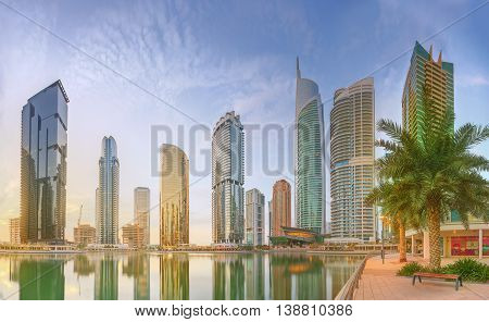 Panoramic view of Business bay and Lake Tower, reflection in a river, Dubai UAE.