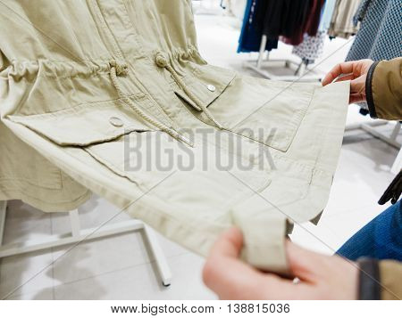 Shopping time concept. Part body buyer customer client wathing touching clothes in botique shop market.