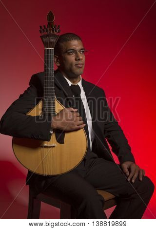 fado musician with a portuguese guitar, studio