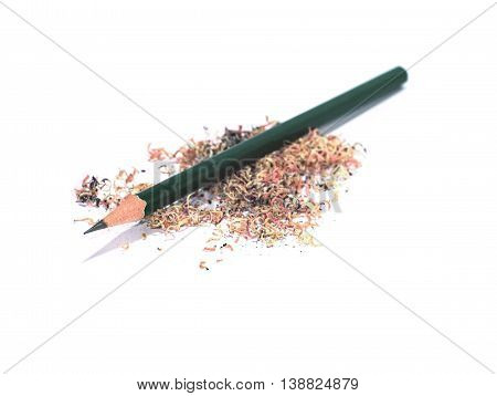 sharpened green pencil on a pile of pencil sawdust isolated on white background