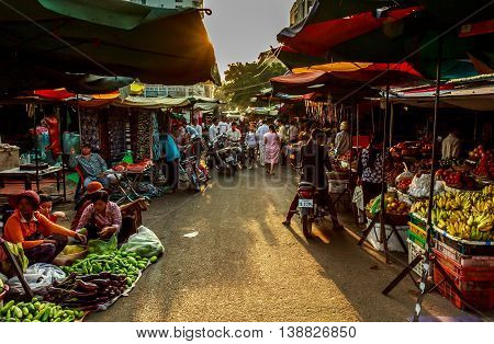 The sun goes down over a market selling fresh fruit in Cambodia