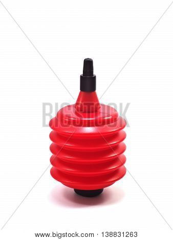 small black and red air dust blower made of plastic used for removing dust off camera lenses stand upright isolated on white background