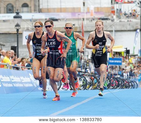 STOCKHOLM - JUL 02 2016: India Lee (GBR) and group of colorful triathletes running in the transition zone in the Women's ITU World Triathlon series event July 02 2016 in Stockholm Sweden