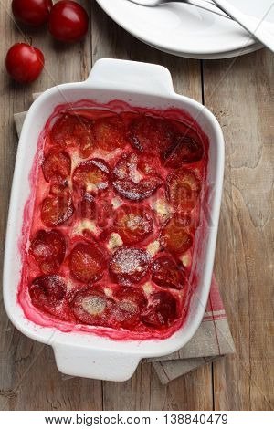 Plum clafoutis in a baking dish