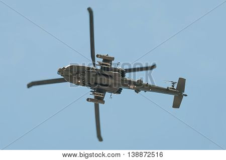 FARNBOROUGH, UK - JULY 14: Underside of a Boeing AH-64 Apache helicopter gunship arriving at Farnborough, UK on July 14, 2016