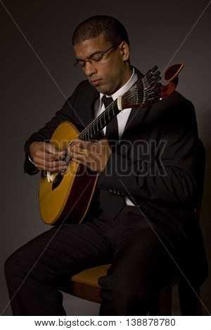 fado musician with a portuguese guitar, studio