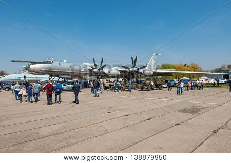 Kyiv Ukraine - April 26 2015: Strategic bomber Tu-95 Bear is in the State Museum of Aviation.People walk viewing the exhibits of the festival 