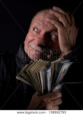 Sly Senior Man Holding Dollar Bills