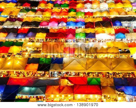 High view of colorful tent retail shop with night light at Talad Rod Fai Night Market Ratchada Bangkok Thailand
