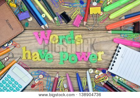 Words have power word and office tools on wooden table