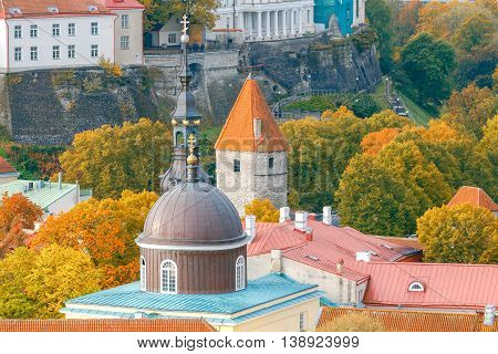 Aerial view of the tiled roofs, spiers and streets in the historical part of old Tallinn.